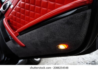 Side Doors Of A Sports Car Upholstered In Red Leather And Alcantara