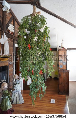 Up side down, Christmas tree, hanging from the ceiling with rope, with simple rural decorations, Bavarian style restaurant, Eastern Shore Winter Festival, Nova Scotia, Canada