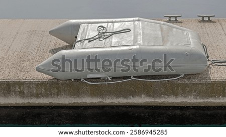 Up Side Down Small Rubber Dinghy Boat at Floating Dock