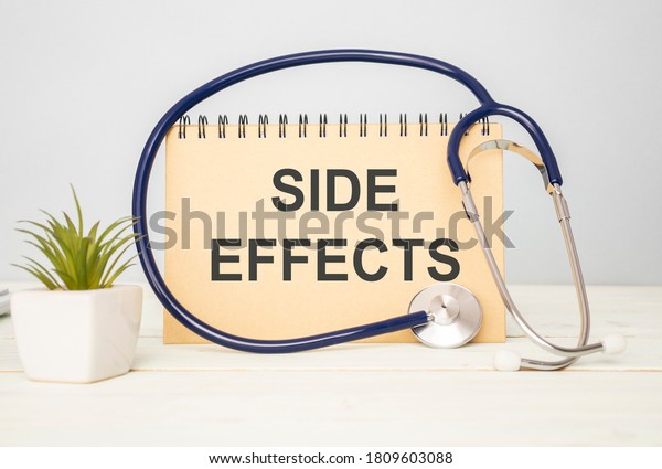 Side Effect word with stethoscope on wooden\
background as medical\
concept