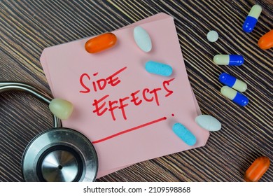 Side Effects write on sticky notes isolated on Wooden Table. medical concept