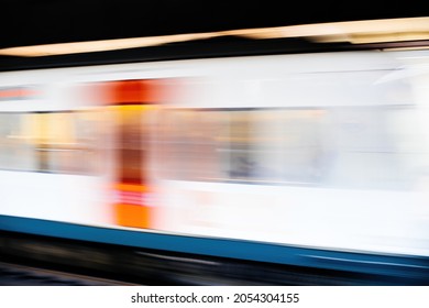 Side Ivew Of Defocused View Of Metro Train Arrival In Station Platform With No People - Light Trails Fast On Time Public Transportation