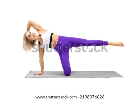 Side kick kneeling exercise. Athletic attractive woman in sportswear practice pilates drill, isolated on white.