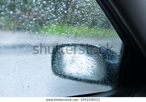 Side mirror of the car. side view mirror in\
water droplets\
