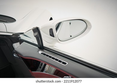 Side mirror on a white lucury sportcar close up