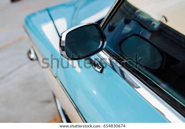 side
mirror of a vintage car, vintage mirror of a
car.
