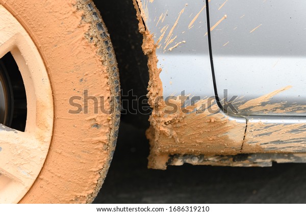 side of a muddy car close\
up