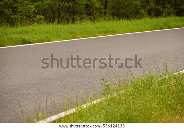 Side of a new road with\
grass