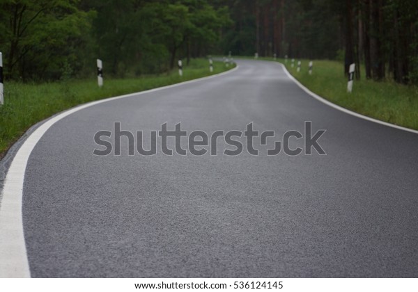 Side of a new road with\
grass