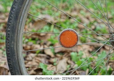 Side Old Plastic Bicycle Reflector Orange Color On The Spokes Of A Bicycle Retro Wheel On The Street During The Day