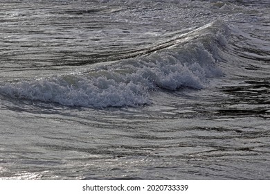 Side on view of the surface of the ocean as a powerful wave breaks, monochrome effect