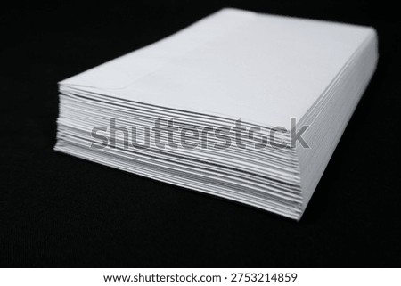 Side perspective of a massive stack of white envelopes