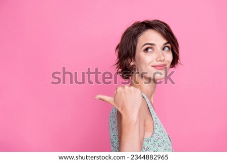 Side photo of young barbie brown hair lady trendy green top point finger mockup look interested trend isolated on pink color background