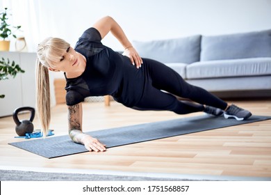 Side Plank Exercise. Athletic Woman Doing Core Workout At Home