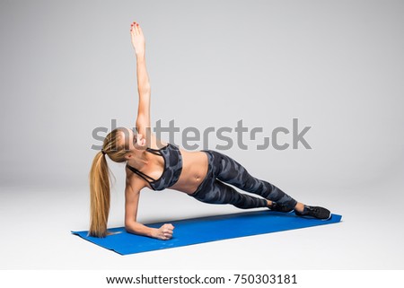 Side Plank. Young woman doing sport exercise.