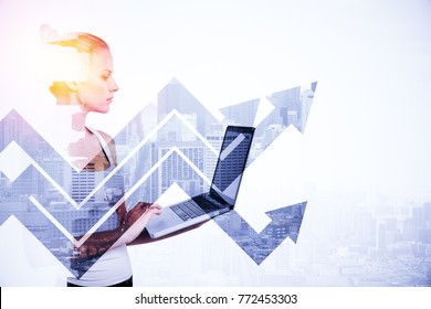 Side portrait of attractive young woman using laptop on abstract light city background with arrows. Technology and success concept. Double exposure 
