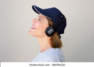 Side Portrait Of Happy Older Woman Enjoying Music With Headphones 