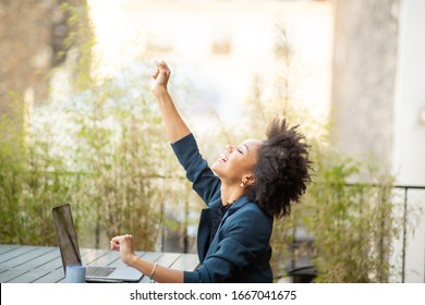 Side Portrait Happy Young African American Business Woman Sitting With Laptop And Hand Raised