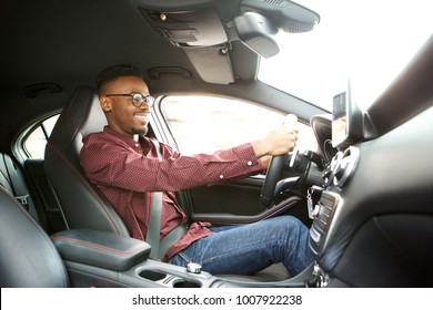 Side Portrait Of Happy Young Black Guy Driving Car