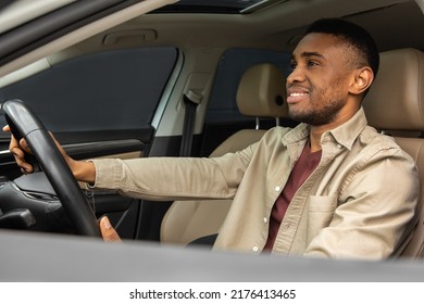 Side Portrait Of Happy Young Black Male Driver Driving A Car