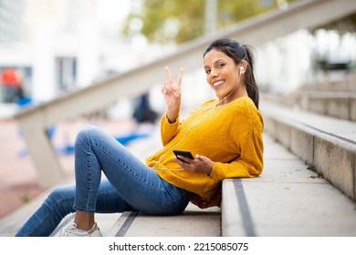 Side Portrait Happy Young Woman Sitting With Mobile Phone Listening To Music