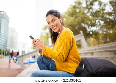 Side Portrait Happy Young Woman Sitting With Cellphone Listening To Music