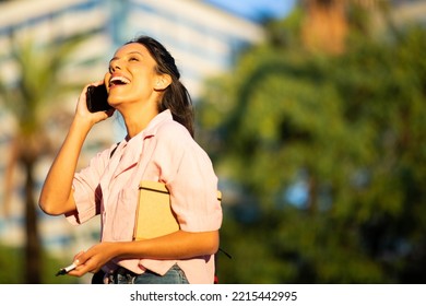 Side Portrait Happy Young Woman Talking And Laughing With Cellphone 