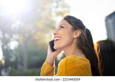 Side Portrait Happy Young Woman Talking With Cellphone Outdoors