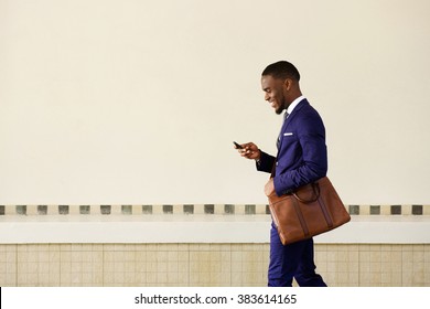 Side Portrait Of A Smiling Business Man With Bag Walking Outdoors 