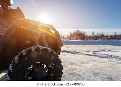 Side POV Close-up Detail View Of Quad Bike Offroad Vehicle Parked In Snowdrift Track On Sunny Snowy Cold Winter Morning Against Clear Blue Sky. ATV Adventure Extreme Sport. Nature Country Tour Drive