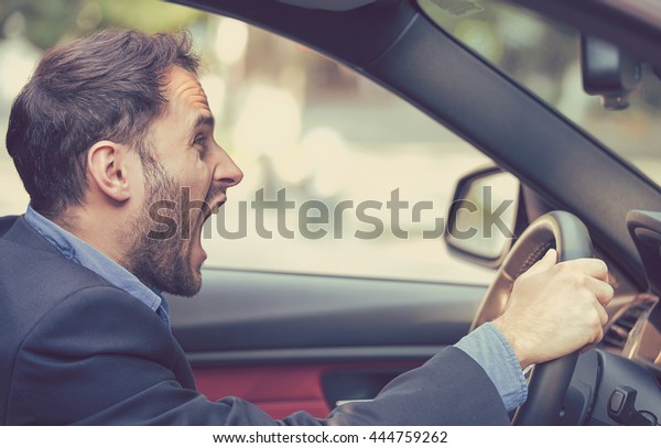 Side profile angry driver. Negative human emotions face\
expression 