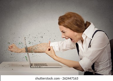 Side Profile Angry Furious Businesswoman Throws A Punch Into Computer, Screaming. Negative Human Emotions, Facial Expressions, Feelings, Aggression, Anger Management Issues Concept