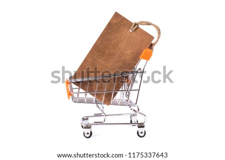 Side profile close up photo of small push card with pricetag inside in the metallic with orange color trolley isolated on white bright background copy space