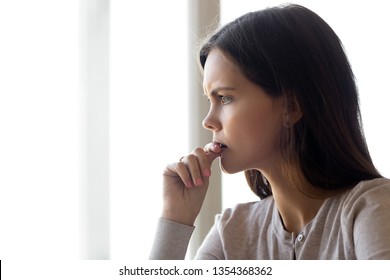 Side Profile Close Up View Face Of Serious Pensive Young Woman Thinking About Problem Difficulties Biting Nail Finger, Feels Nervous Frustrated Puzzled, Hard Make Decision Stressful Situation Concept