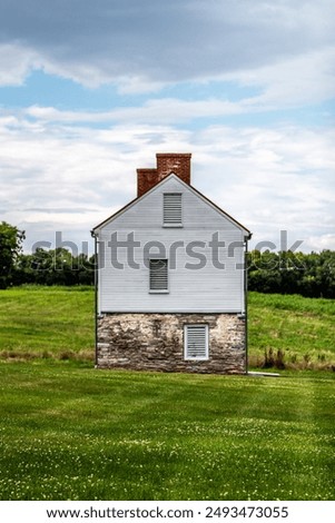 Side profile of historic barn structure (Best Farm) in a green field of Monocacy National Battlefield