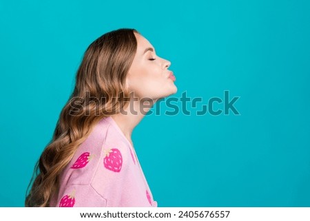 Side profile photo of adorable nice young girl curls hair look mockup closed eyes first kiss in her life isolated on blue color background