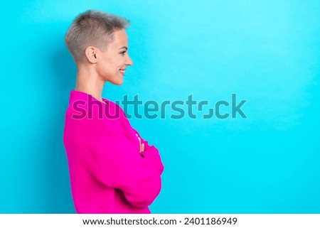 Side profile photo of cheerful woman with bob hairdo dressed pink sweater hands crossed look empty space isolated on teal color background