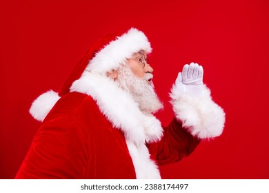 Side profile photo of excited grandfather wear stylish trendy santa costume scream in empty space isolated on red color background - Shutterstock ID 2388174497
