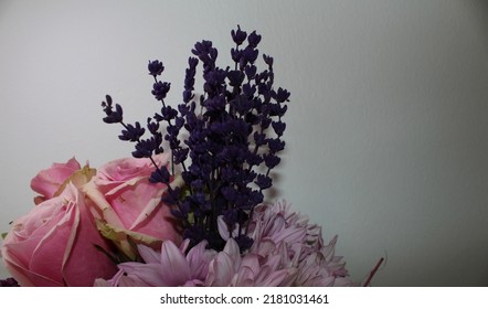 Side Profile Photo From Vibrant Flowers In Front Of A White Background, Behind Of A Bouquet Of Pink Roses, Pink Chrysanthemums, Purple Lavenders