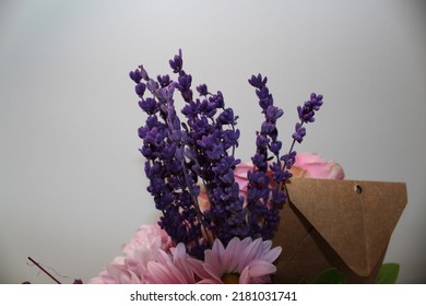 Side Profile Photo From Vibrant Flowers In Front Of A White Background, Behind Of A Bouquet Of Pink Roses, Pink Chrysanthemums, Purple Lavenders