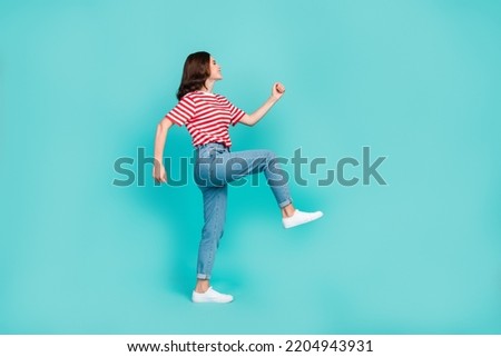 Side profile photo of young adorable woman walk street empty space career manager professional worker success isolated on aquamarine color background