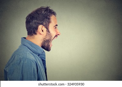 Side Profile Portrait Of Young Angry Man Screaming 