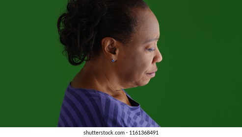 Side Profile Of Sad Old Black Woman On Green Screen