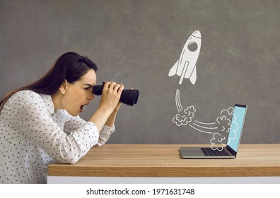 Side Profile View Astonished Lady Looking In Binoculars At Rocket Flying Out Laptop Computer Screen. Surprised Girl Watching Accelerated Growth Of Modern Digital Startup Of Successful Business Rival