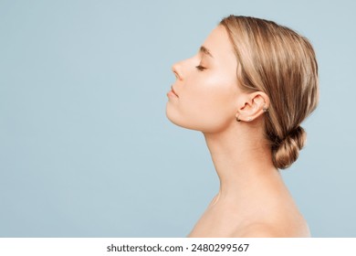 Side profile view beautiful half naked topless young woman 20s with nude make up raise up head with close eyes isolated on plain pastel blue background Skin care healthcare cosmetic procedures concept