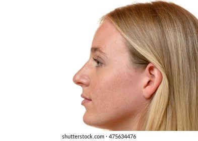Side profile view of the face of an attractive blond woman with her long hair tucked behind her ear isolated on white