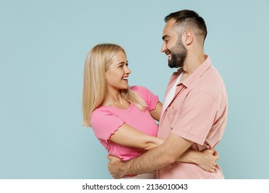 Side Profile View Young Fun Smiling Happy Lovely Couple Two Friends Family Man Woman20s In Casual Clothes Hug Together Isolated On Pastel Plain Light Blue Background Studio People Lifestyle Concept.