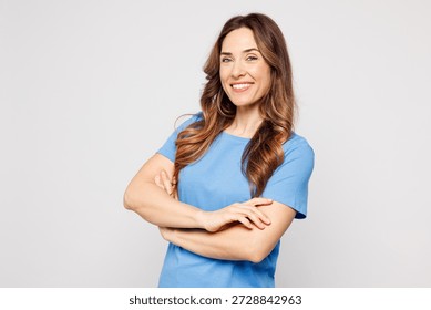 Side profile view young fun Caucasian woman wears blue t-shirt casual clothes hold hands crossed folded look camera isolated on plain solid white color background studio portrait. Lifestyle concept