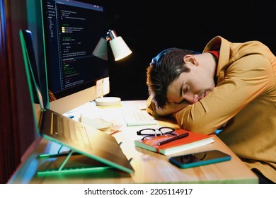 Side Profile View Young Software Engineer IT Specialist Programmer Man In Shirt Work Late At Night At Home Writing Code On Laptop Pc Computer Sleep Put Head On Table Desk. Program Development Concept