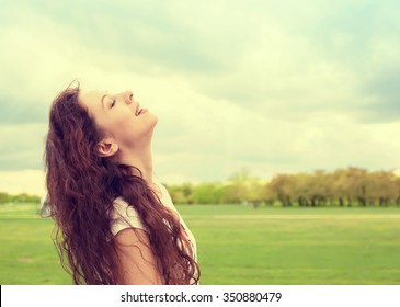 Side profile woman smiling looking up to blue sky celebrating enjoying freedom. Positive emotion face expression life perception success, peace of mind concept. Free happy girl 